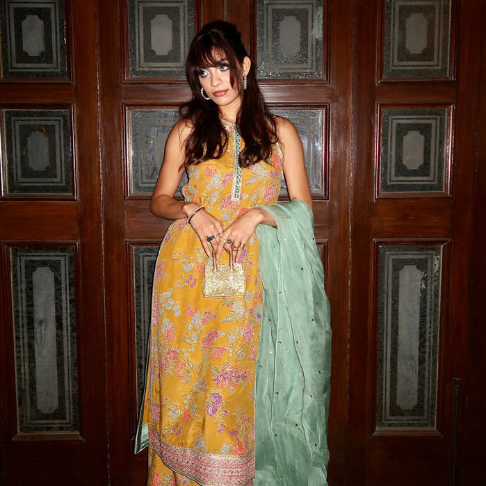 Picture of Natalia dons our mustard yellow shirt with intricately embellished motifs and a sea green sequins-sprayed organza dupatta